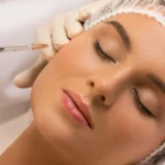 Woman receiving facial glutathione injection at clinic